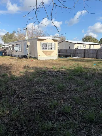 a view of a big yard with table and chairs in patio