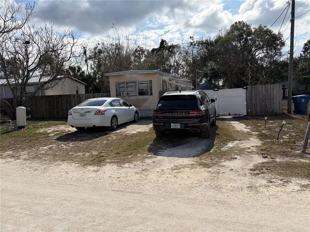 a couple of cars parked in a yard