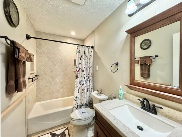 a bathroom with a sink mirror toilet and bathtub