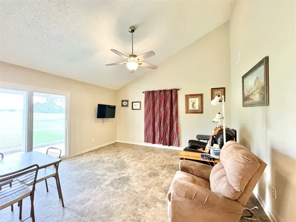 a view of a livingroom with furniture and a window