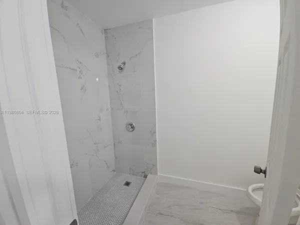 a bathroom with a sink and shower