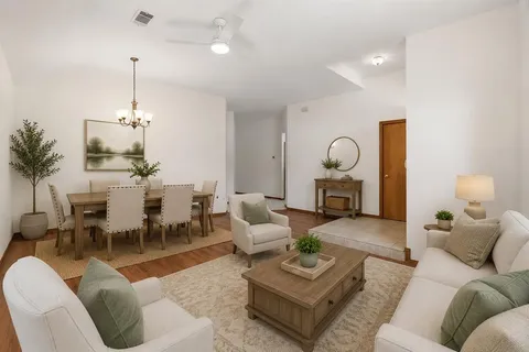 a living room with furniture and a chandelier