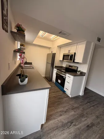 a kitchen with stainless steel appliances a sink and a stove