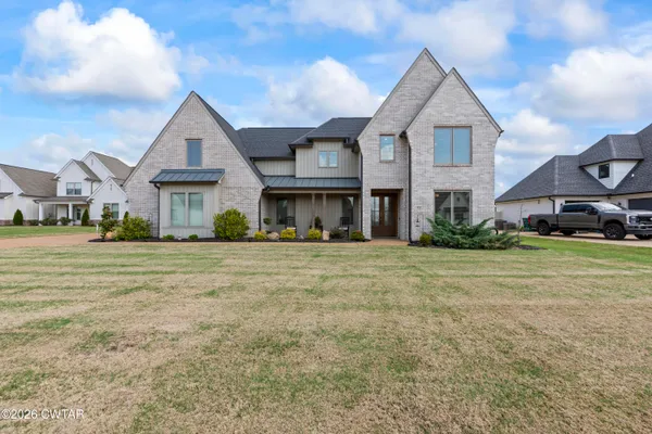 a front view of a house with a yard