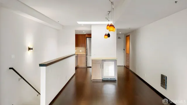 a view of main area with wooden floor and stairs