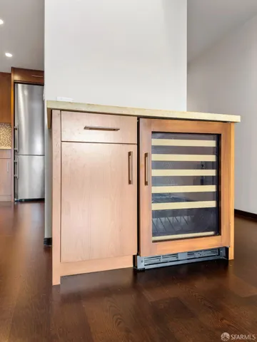 a view of a room with wooden floor and a cabinet