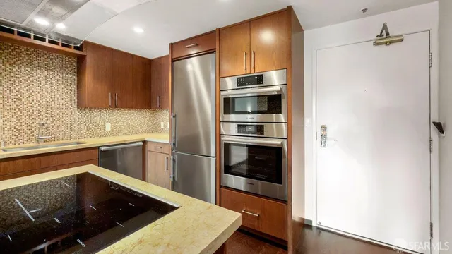 a kitchen with a refrigerator and a sink