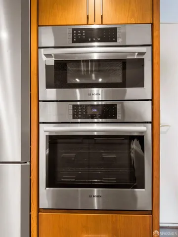 a stove top oven sitting inside of a kitchen