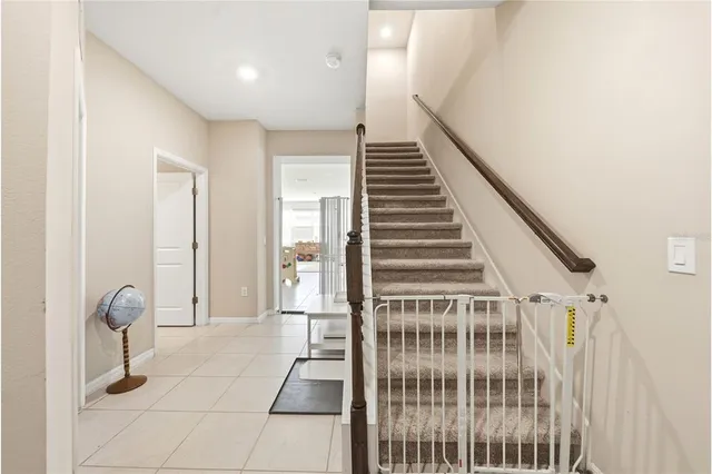 a view of a hallway with windows and stairs