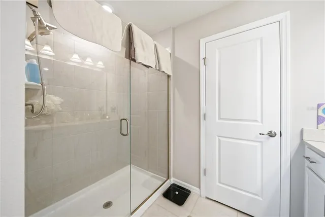 a bathroom with a shower and a glass door