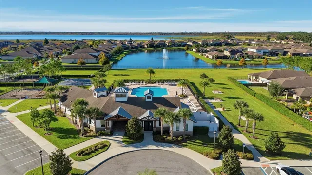 an aerial view of a yard with swimming pool and ocean view