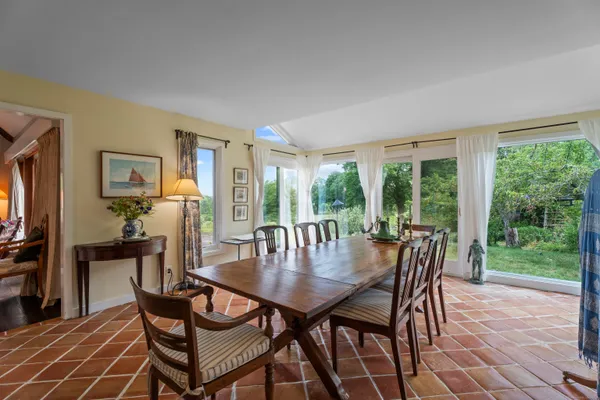 a view of hallway with furniture and a floor to ceiling window
