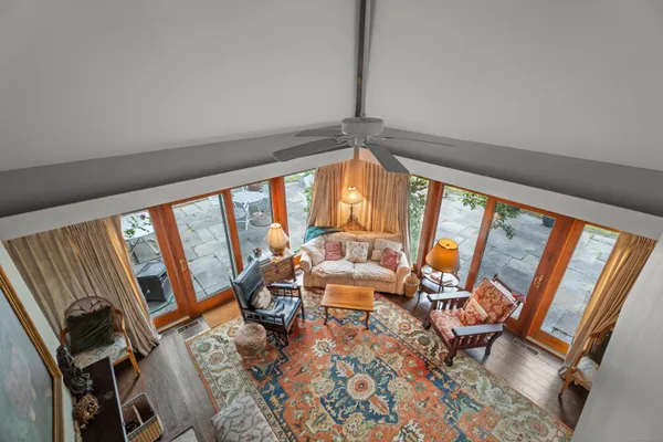 a living room with furniture and a wooden floor
