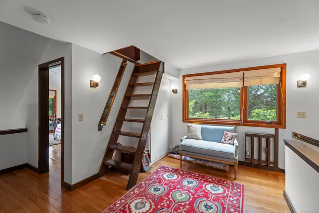 a living room with furniture a rug and a large window