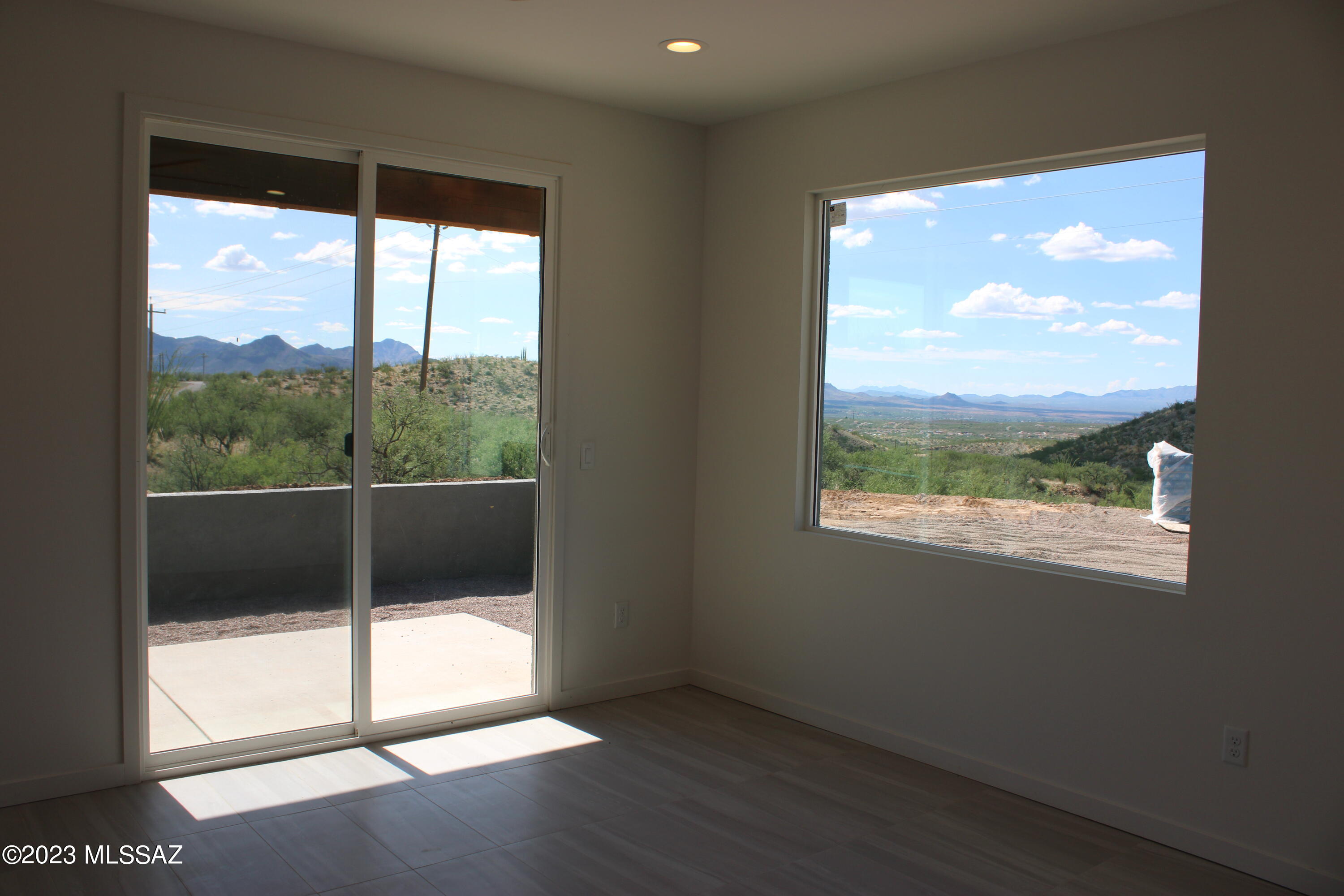 1715 Calle Playa Rio Rico, AZ 85648 - Photo 25 of 37 a view of an empty room with wooden floor and a window