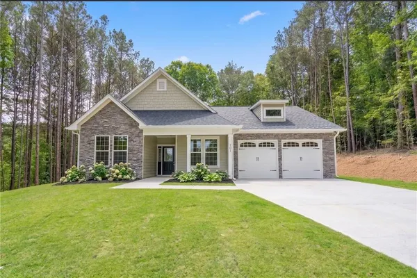 a front view of a house with garden