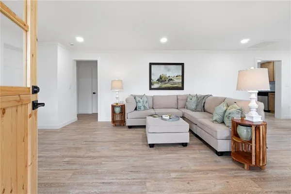 a living room with furniture and a wooden floor