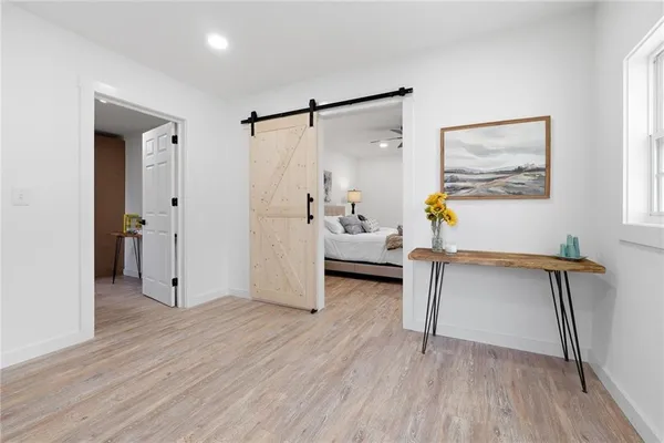 a living room with furniture and a wooden floor