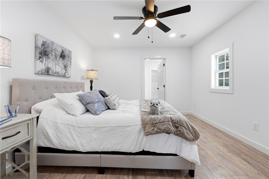 4015 Maple Grove Church Road Resaca, GA 30735 - Photo 15 of 42 a bedroom with a bed and a chandelier