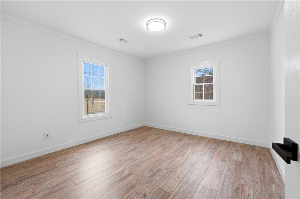 4015 Maple Grove Church Road Resaca, GA 30735 - Photo 22 of 42 an empty room with wooden floor and a window