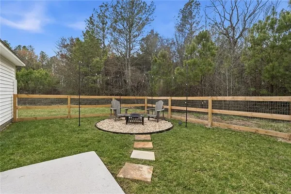 a backyard of a house with table and chairs