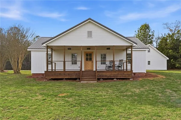 a front view of house with yard and green space