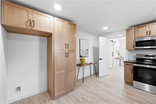 a kitchen with stainless steel appliances a refrigerator and a stove top oven
