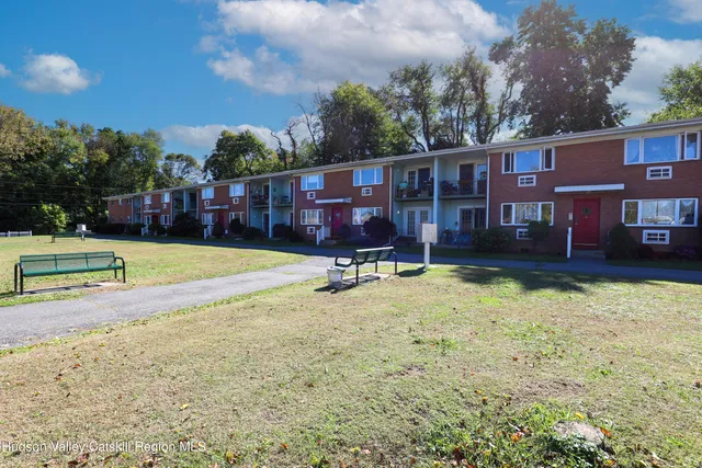 a view of swimming pool with a yard and wooden fence