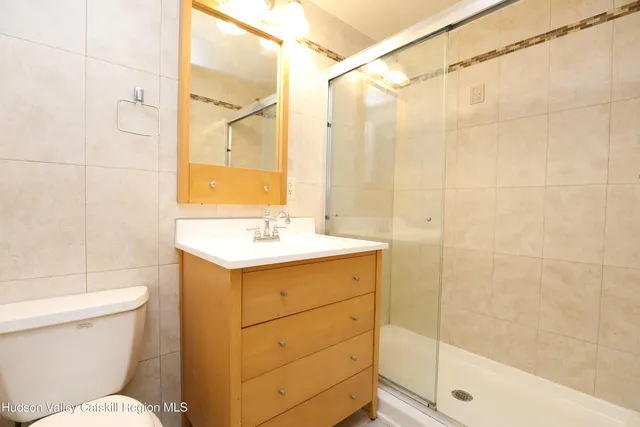 a bathroom with a sink mirror vanity and toilet