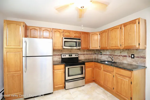 a kitchen with a refrigerator sink and microwave