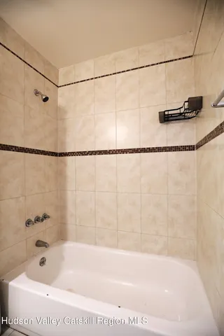 a bathroom with a shower and a shower