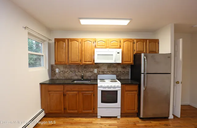 a kitchen with a stove a refrigerator and a sink