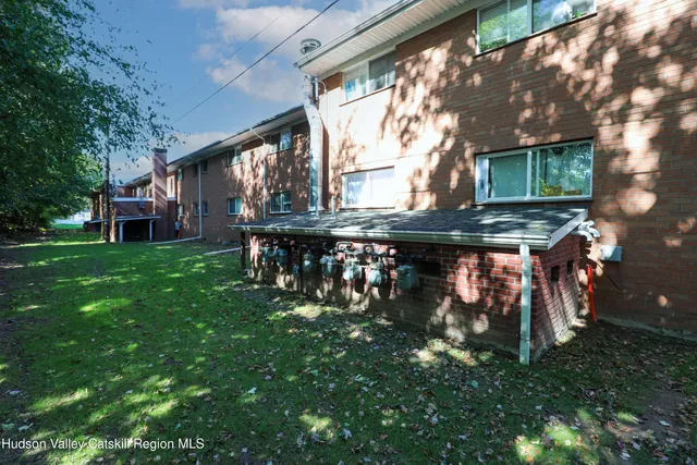 a backyard of a house with table and chairs