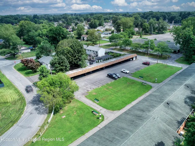 an aerial view of a house with a yard and lake view