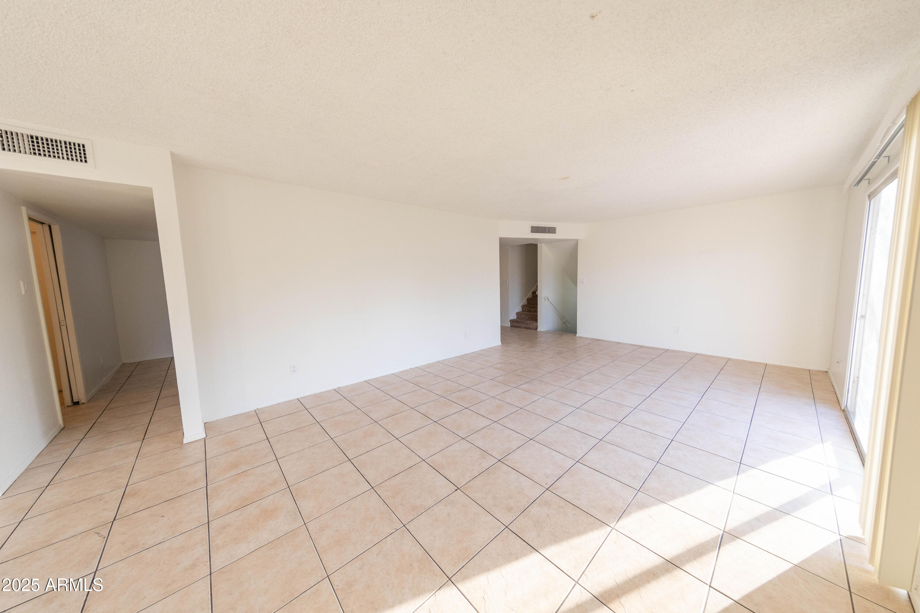 1349 East Donner Drive Tempe, AZ 85282 - Photo 7 of 26 a view of an empty room and wooden floor