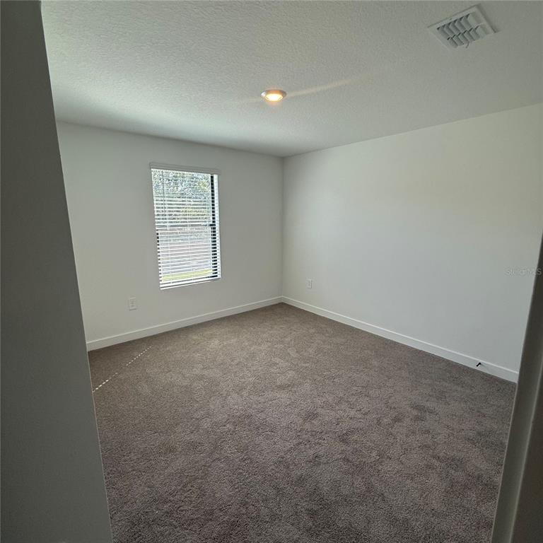 3245 Sustainable Way Kissimmee, FL 34747 - Photo 13 of 35 an empty room with windows