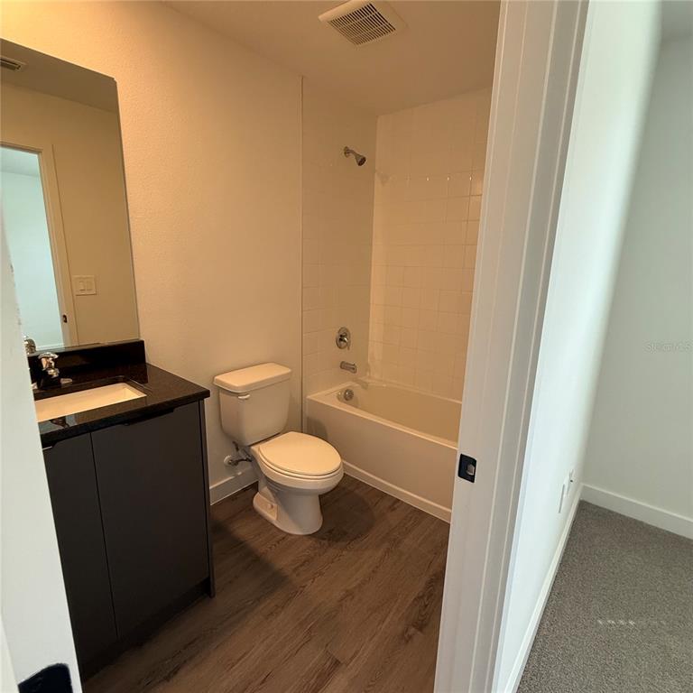 3245 Sustainable Way Kissimmee, FL 34747 - Photo 16 of 35 a white toilet sitting next to a sink