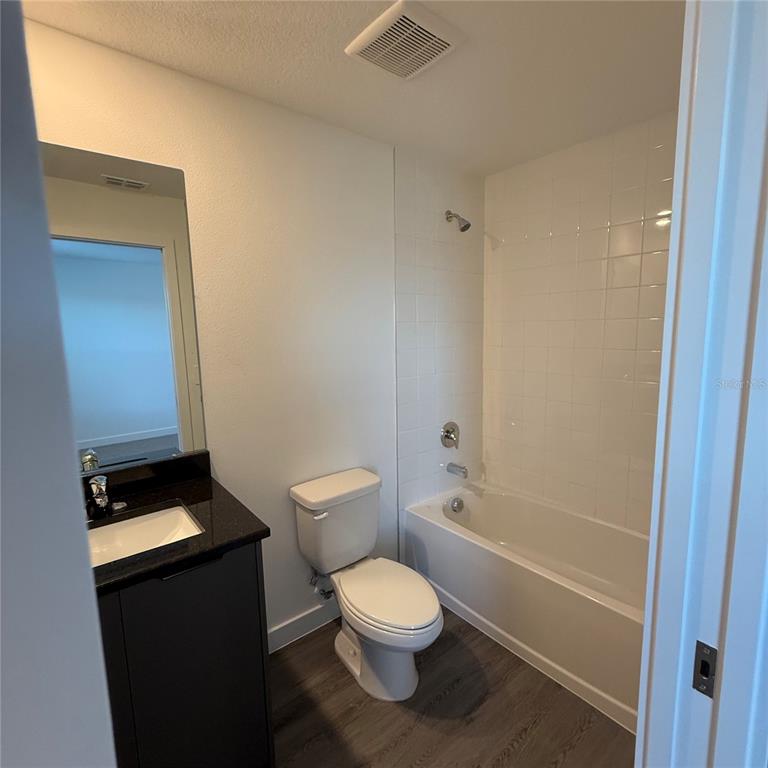 3245 Sustainable Way Kissimmee, FL 34747 - Photo 21 of 35 a bathroom with a toilet a sink and a shower