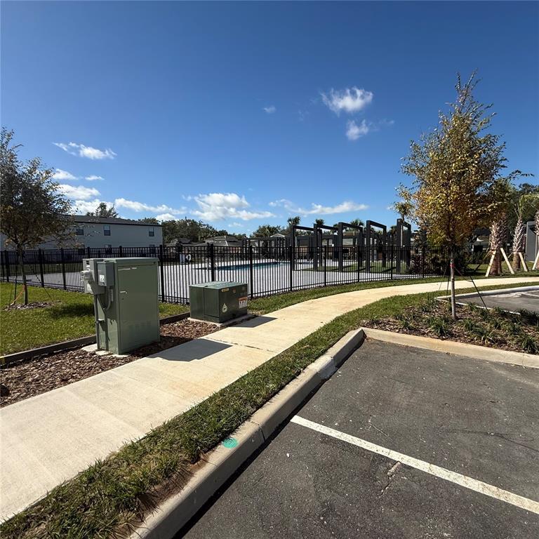 3245 Sustainable Way Kissimmee, FL 34747 - Photo 27 of 35 a view of swimming pool with a yard and sitting area
