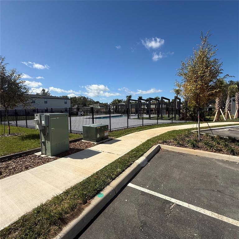 3245 Sustainable Way Kissimmee, FL 34747 - Photo 28 of 35 a view of swimming pool with a yard and sitting area