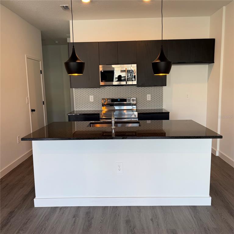 3245 Sustainable Way Kissimmee, FL 34747 - Photo 5 of 35 a kitchen with a table and chairs