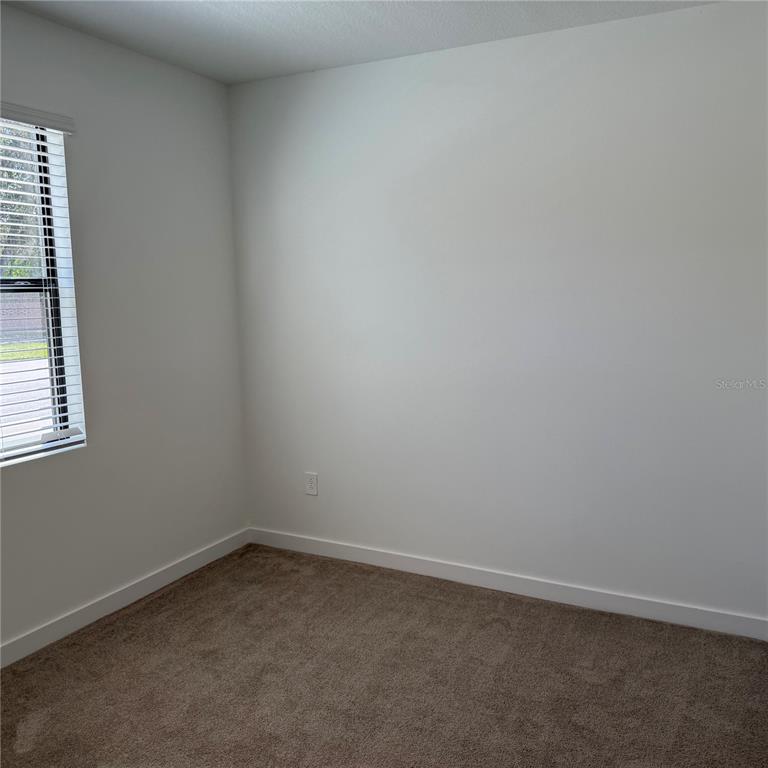3245 Sustainable Way Kissimmee, FL 34747 - Photo 10 of 35 an empty room with a window