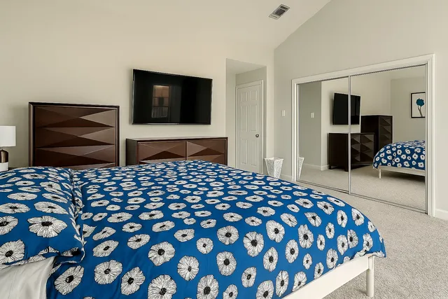 a bedroom with a bed and a view of bathroom