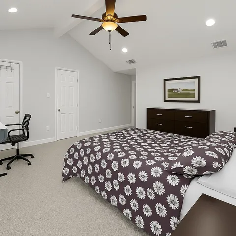 a bedroom with a bed and dresser