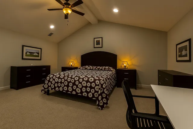 a bedroom with a bed and a chandelier