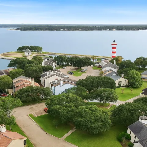 an aerial view of a house with a yard and lake view