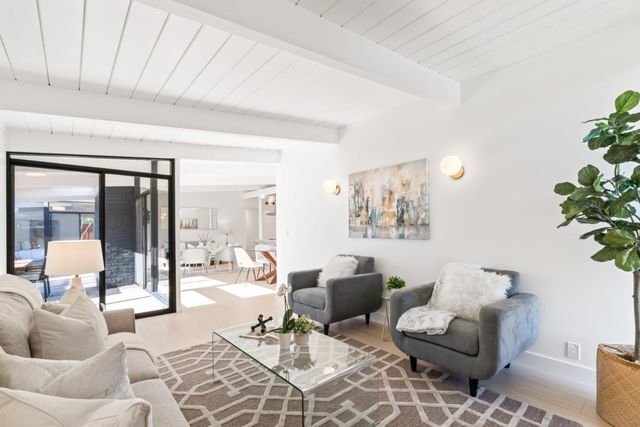 a bedroom with a large bed and a balcony view