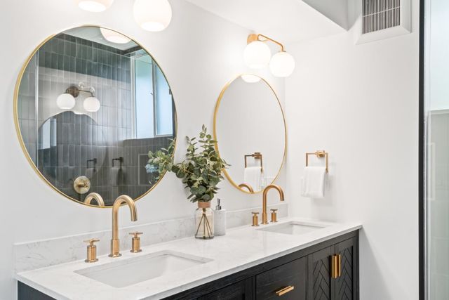 a bathroom with a shower sink and mirror