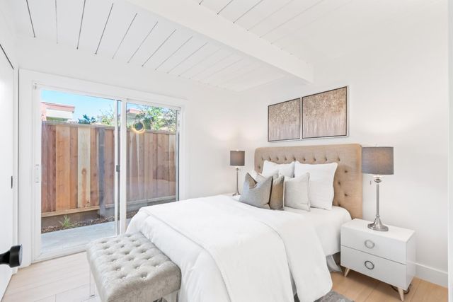 a bedroom with a bed and a night stand