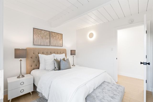 a bedroom with a bed and a tv